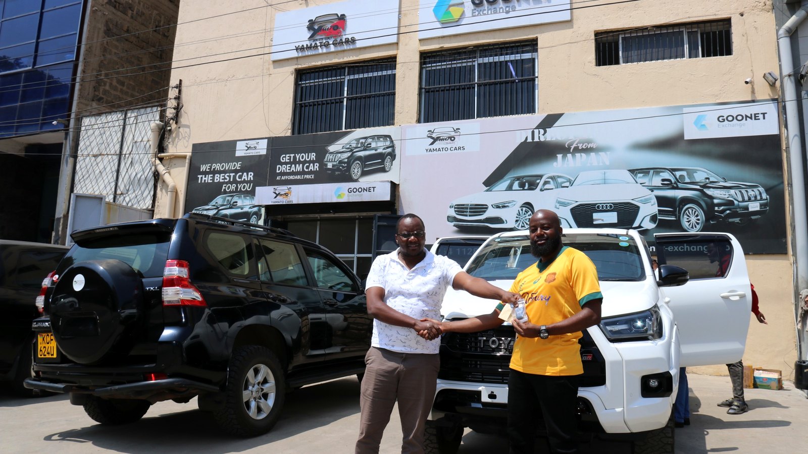 Customer receiving keys to a Toyota Hilux GR at Yamato Cars Nairobi